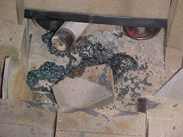furnace interior shows burner with copper slag.jpg